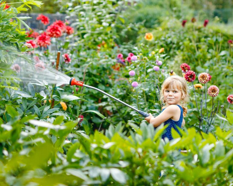 Giessen: kleines Mädchen giesst die Blumen